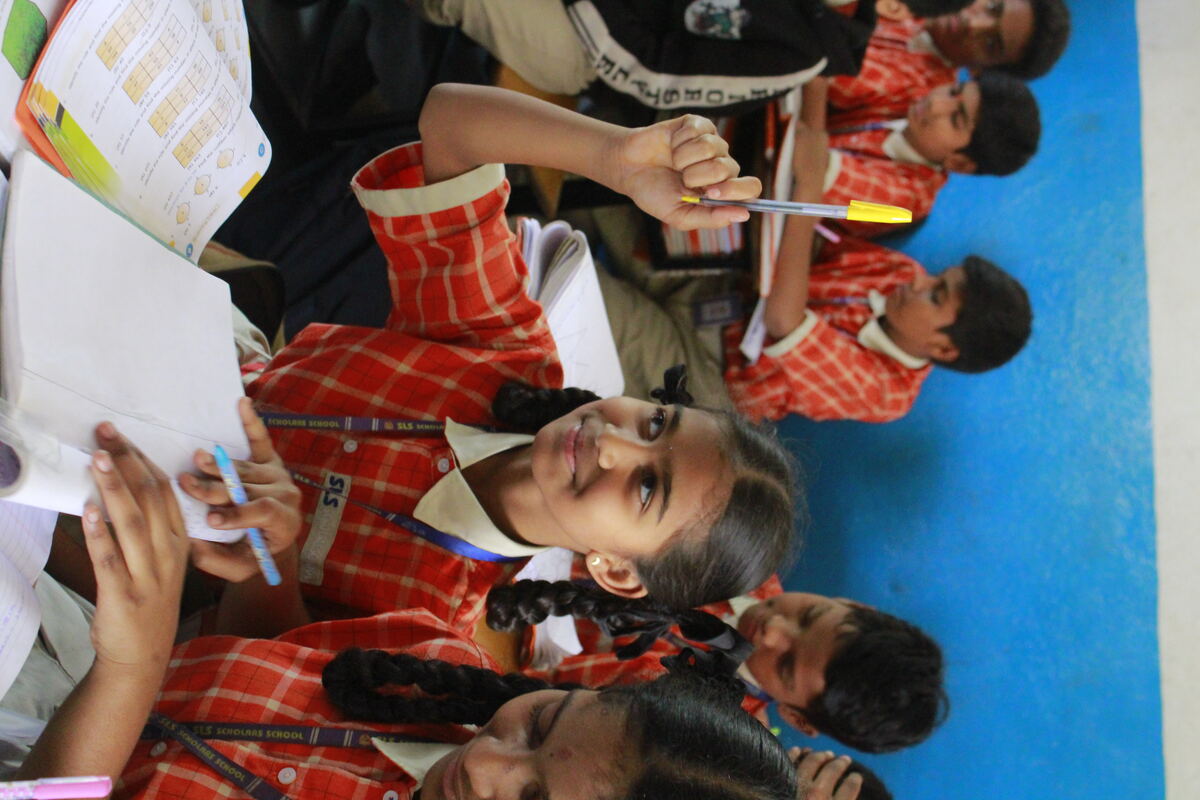 SLS student raising her hand in class